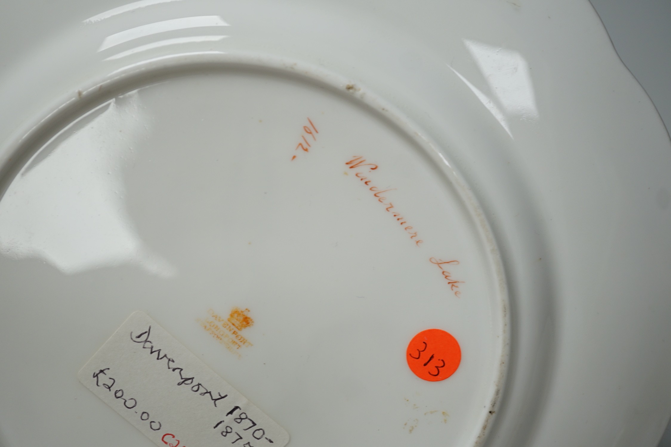 A Copeland plate decorated in Chelsea style with exotic birds on a mazarine blue ground, a similar plate probably Coalport, a Davenport plate with Windemere Lake and a Alderley pierced dish